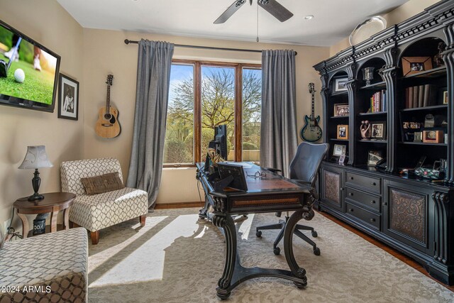 carpeted office featuring ceiling fan