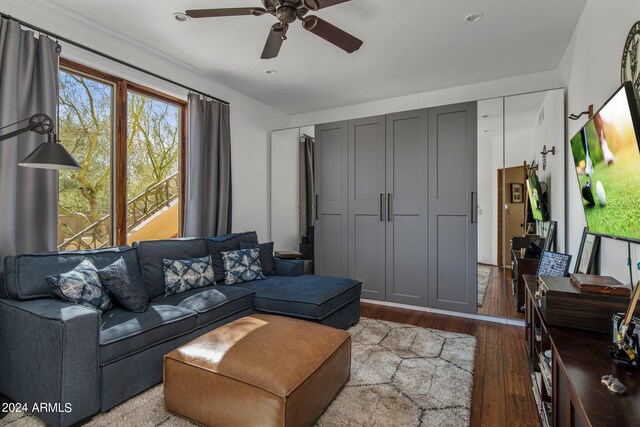 living room with wood-type flooring and ceiling fan