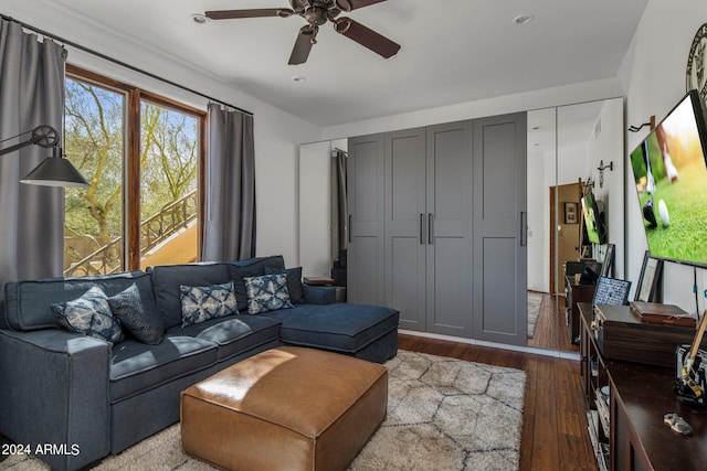 living room with a ceiling fan and hardwood / wood-style floors