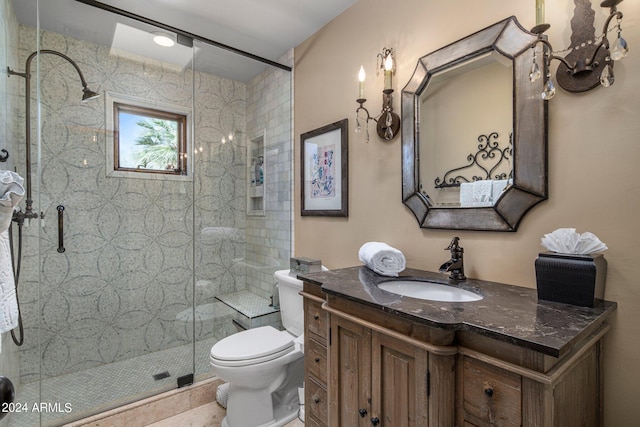 full bath with vanity, a stall shower, and toilet