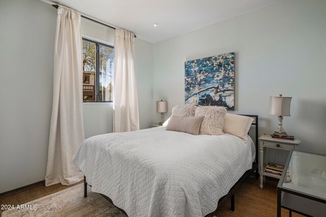 bedroom with dark wood-type flooring