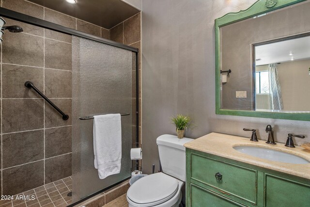 bathroom with vanity, toilet, and an enclosed shower