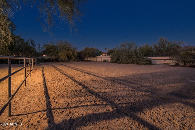 view of yard with a rural view and fence