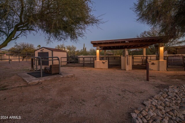 yard at dusk with a storage unit