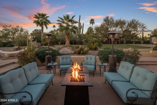 view of patio / terrace with an outdoor living space with a fire pit