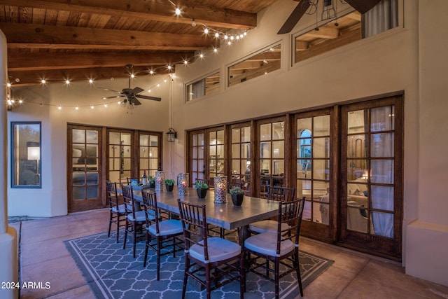 dining room with french doors, a ceiling fan, wooden ceiling, and beamed ceiling