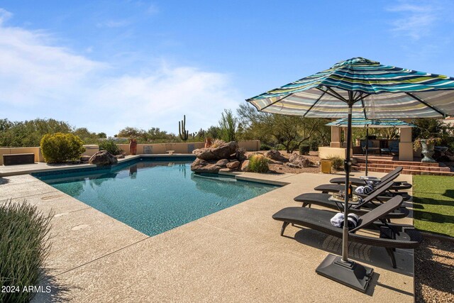 view of swimming pool featuring a patio area