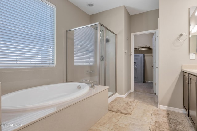 bathroom with vanity, tile patterned floors, and plus walk in shower