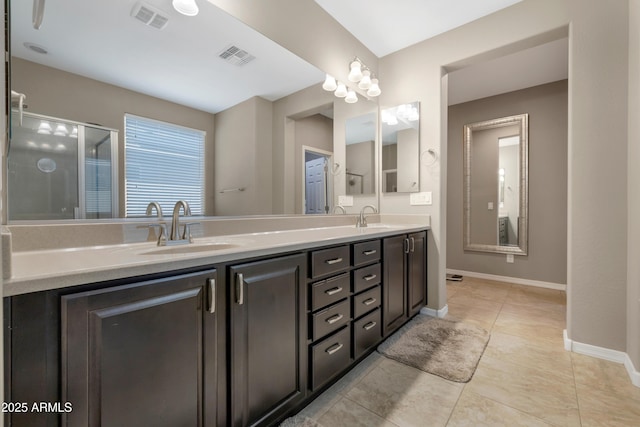 bathroom featuring vanity, tile patterned floors, and a shower with shower door