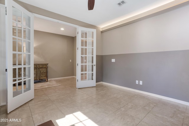 empty room featuring light tile patterned floors, french doors, and ceiling fan