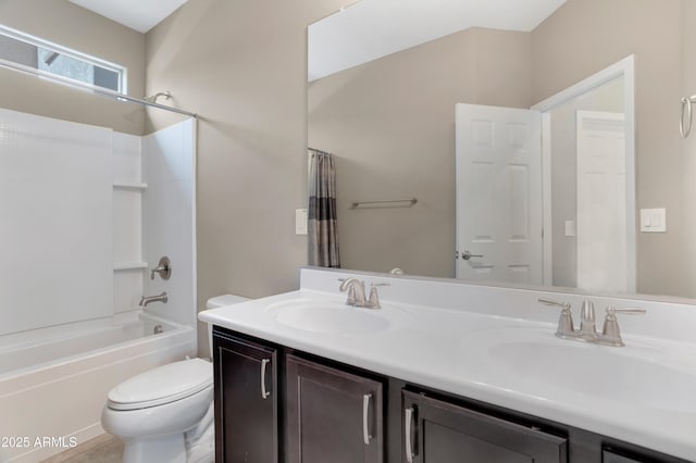 full bathroom featuring shower / tub combo, vanity, and toilet