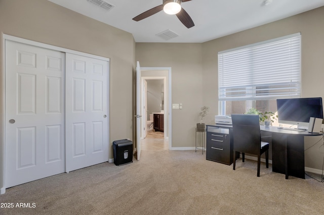 carpeted home office featuring ceiling fan