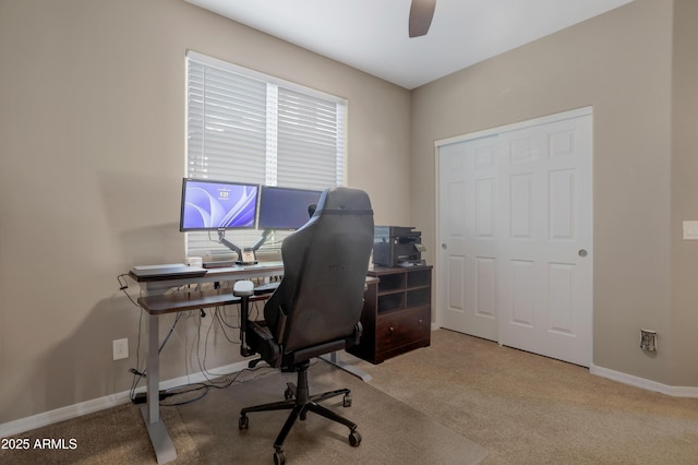 carpeted home office featuring ceiling fan