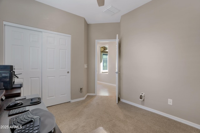 exercise area with ceiling fan and light carpet