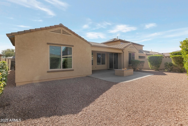 back of house with a patio