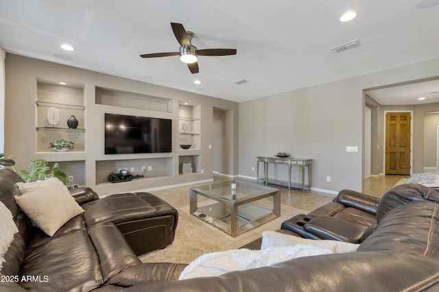 tiled living room featuring ceiling fan and built in features