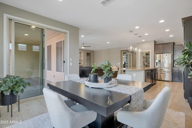 tiled dining area with sink and ceiling fan