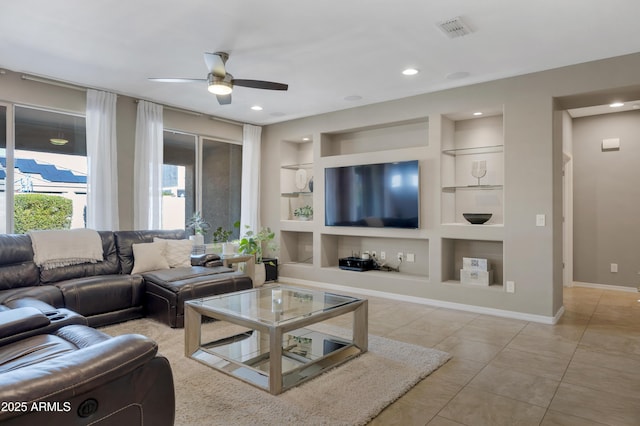 tiled living room featuring ceiling fan and built in features