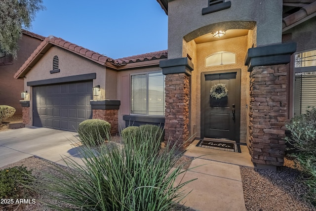 view of exterior entry with a garage