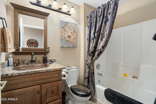 bathroom with shower / tub combo, toilet, and vanity