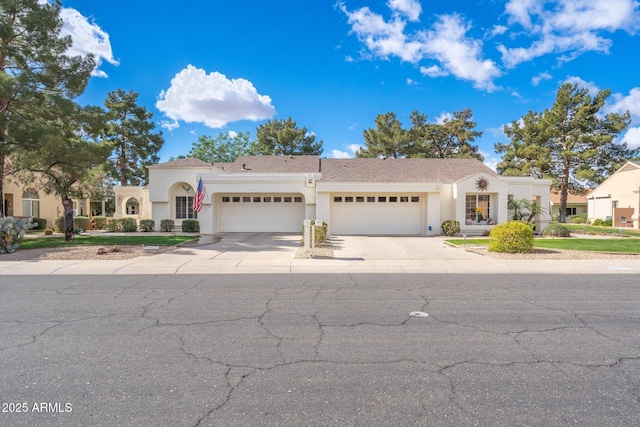 mediterranean / spanish-style house with stucco siding, an attached garage, and driveway