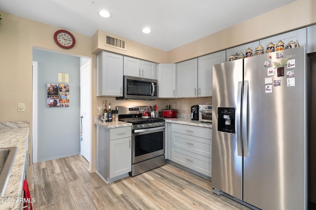 kitchen with light wood finished floors, visible vents, recessed lighting, and stainless steel appliances