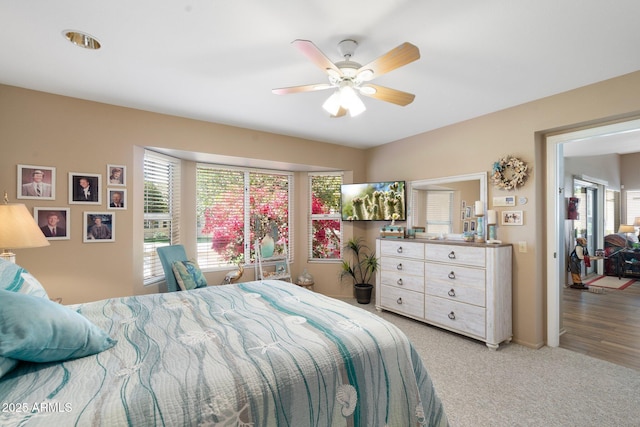 bedroom with light colored carpet and ceiling fan