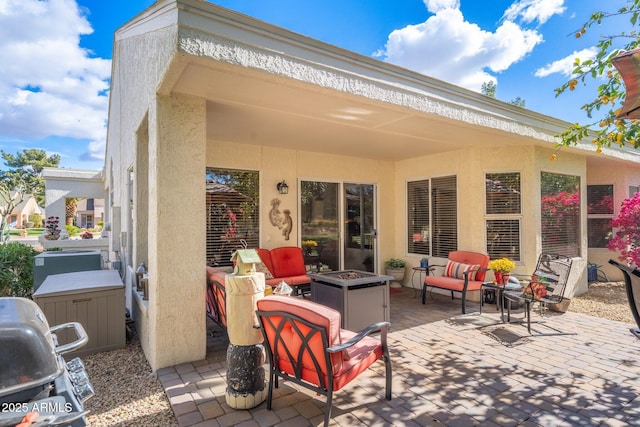 view of patio / terrace featuring area for grilling and an outdoor living space with a fire pit