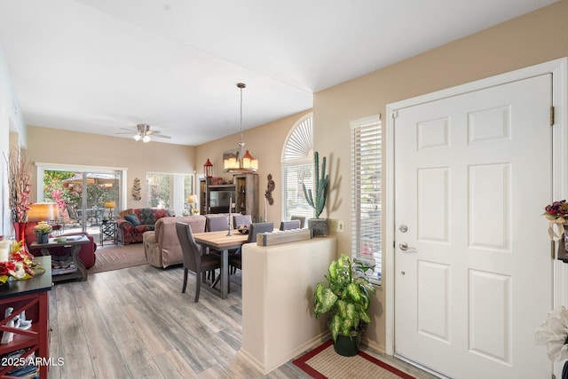 foyer featuring a healthy amount of sunlight, a ceiling fan, and light wood finished floors