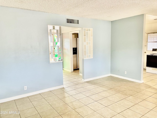 5522 E Colby St, Mesa, AZ 85205 - empty room with light tile patterned floors and a textured ceiling