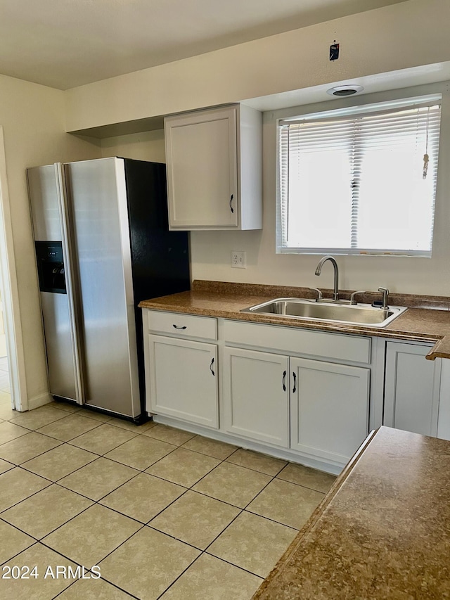 5522 E Colby St, Mesa, AZ 85205 - kitchen with stainless steel fridge with ice dispenser, dark countertops, light tile patterned floors, and white cabinetry
