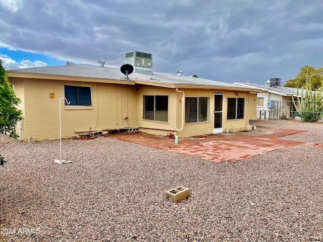 rear view of house featuring a patio area and central air condition unit