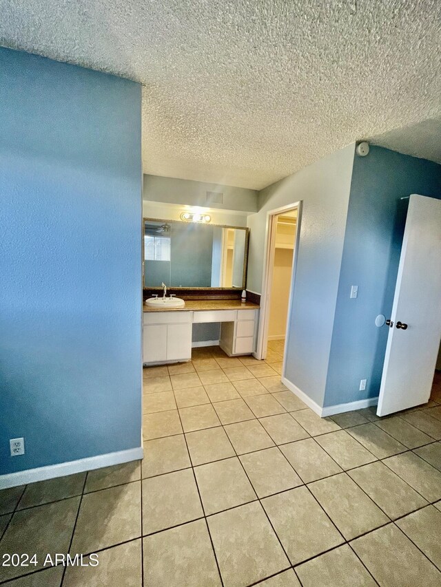 5522 E Colby St, Mesa, AZ 85205 - bathroom featuring tile patterned flooring, vanity, and a textured ceiling
