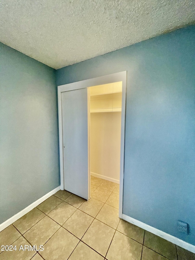 5522 E Colby St, Mesa, AZ 85205 - unfurnished bedroom featuring tile patterned floors, a closet, and a textured ceiling