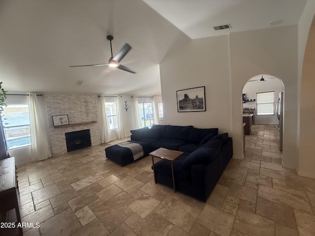 10029 S 44th St, Phoenix, AZ 85044 - living area featuring stone tile floors, a ceiling fan, healthy amount of natural light, arched walkways, and lofted ceiling