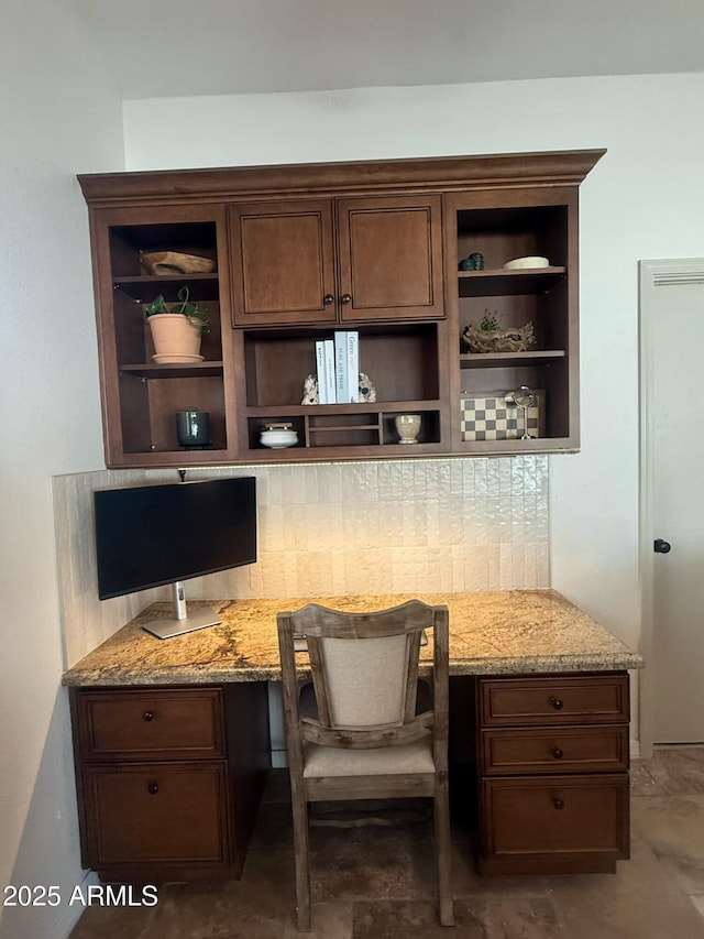 10029 S 44th St, Phoenix, AZ 85044 - kitchen featuring open shelves, built in desk, light stone counters, and dark brown cabinetry