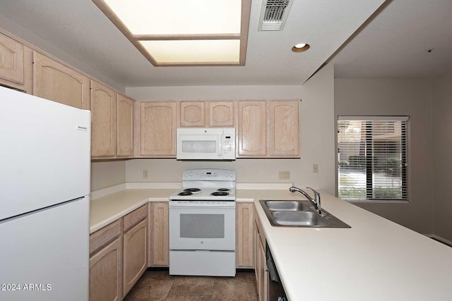 kitchen featuring sink, light brown cabinets, and white appliances