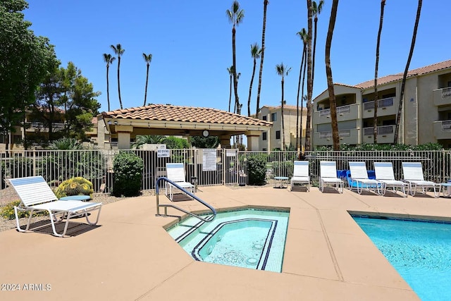 view of swimming pool with a gazebo, a patio area, and a hot tub