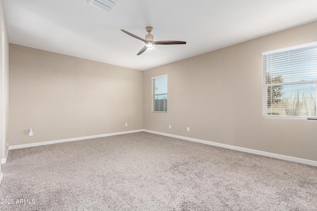 spare room featuring ceiling fan and carpet