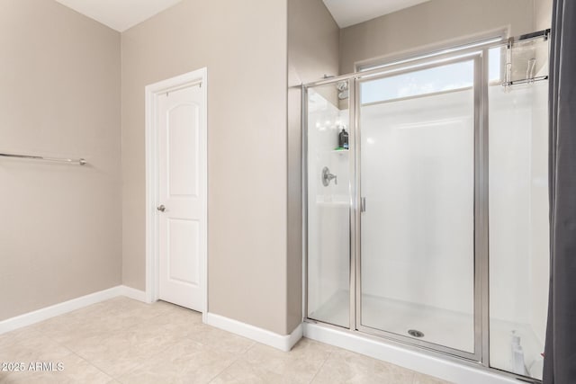 bathroom with tile patterned flooring and a shower with door