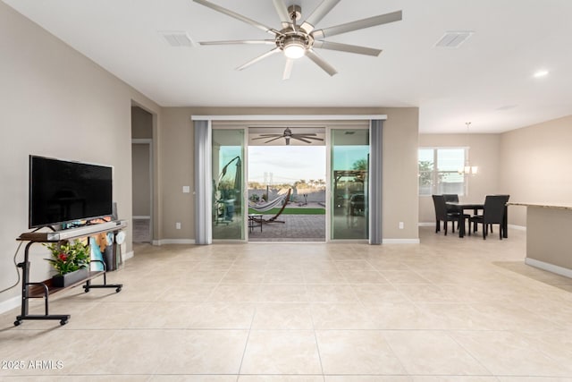 living room with light tile patterned floors and an inviting chandelier