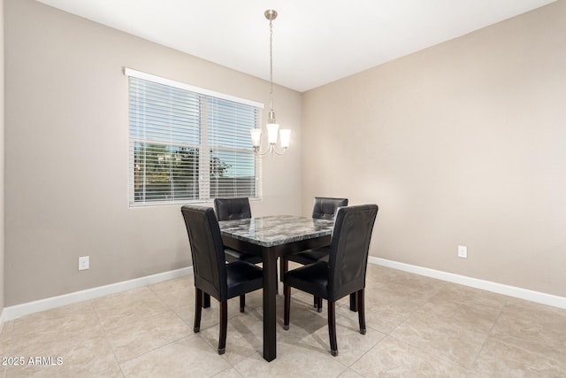 tiled dining area with a chandelier