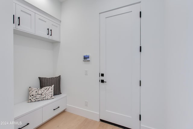 mudroom with light wood-style flooring and baseboards