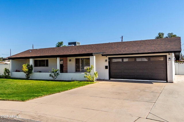 7811 N 32nd Ave, Phoenix, AZ 85051 - ranch-style home with a garage, concrete driveway, a front lawn, and a shingled roof