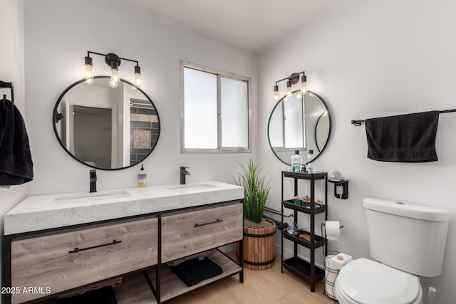7811 N 32nd Ave, Phoenix, AZ 85051 - full bath with double vanity, toilet, wood finished floors, and a sink
