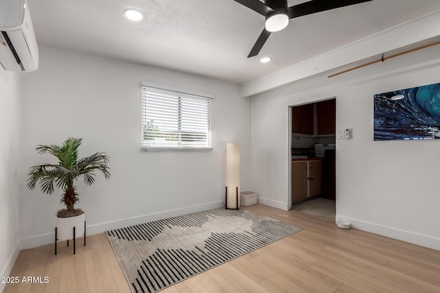 7811 N 32nd Ave, Phoenix, AZ 85051 - interior space with ceiling fan, baseboards, a wall unit AC, and wood finished floors
