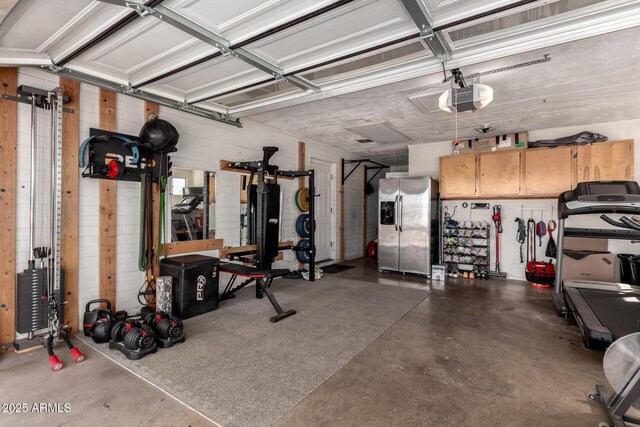 7811 N 32nd Ave, Phoenix, AZ 85051 - garage with a garage door opener and stainless steel refrigerator with ice dispenser