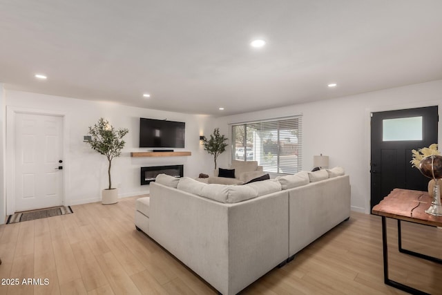 7811 N 32nd Ave, Phoenix, AZ 85051 - living room featuring recessed lighting, baseboards, a glass covered fireplace, and light wood-style flooring
