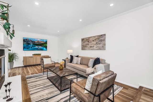 7832 E Via Marina, Scottsdale, AZ 85258 - living room featuring ornamental molding, recessed lighting, wood finished floors, and a glass covered fireplace