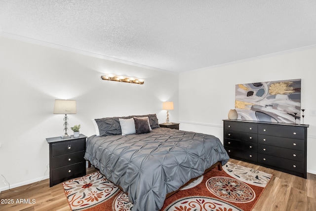 7832 E Via Marina, Scottsdale, AZ 85258 - bedroom with wood finished floors, ornamental molding, and a textured ceiling